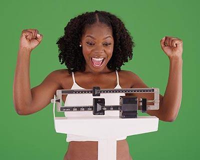 photo of woman on scale, excited by weight loss