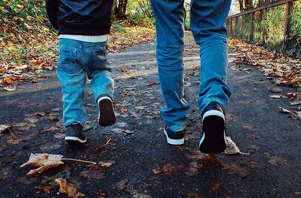 photos of father and son walking on leaf strewn lane