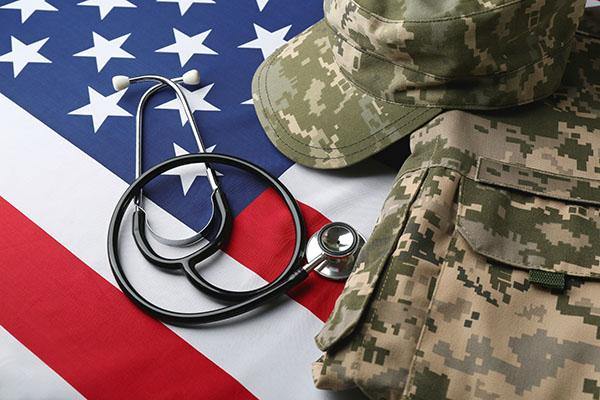 photo of American flag with fatigues and stethoscope