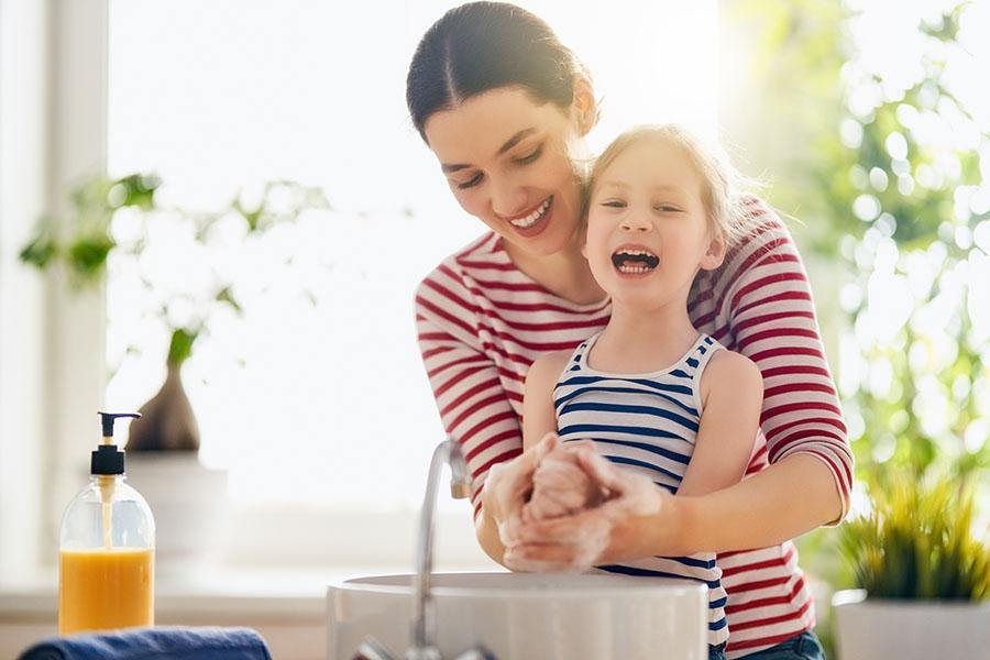 photo of mother and daughter washing hands